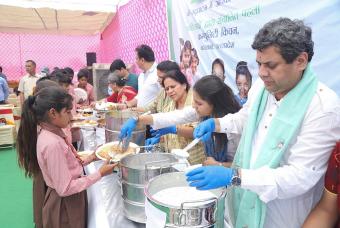 Dignitaries serve mid-day meals to government school children at the Barsana kitchen in Uttar Pradesh